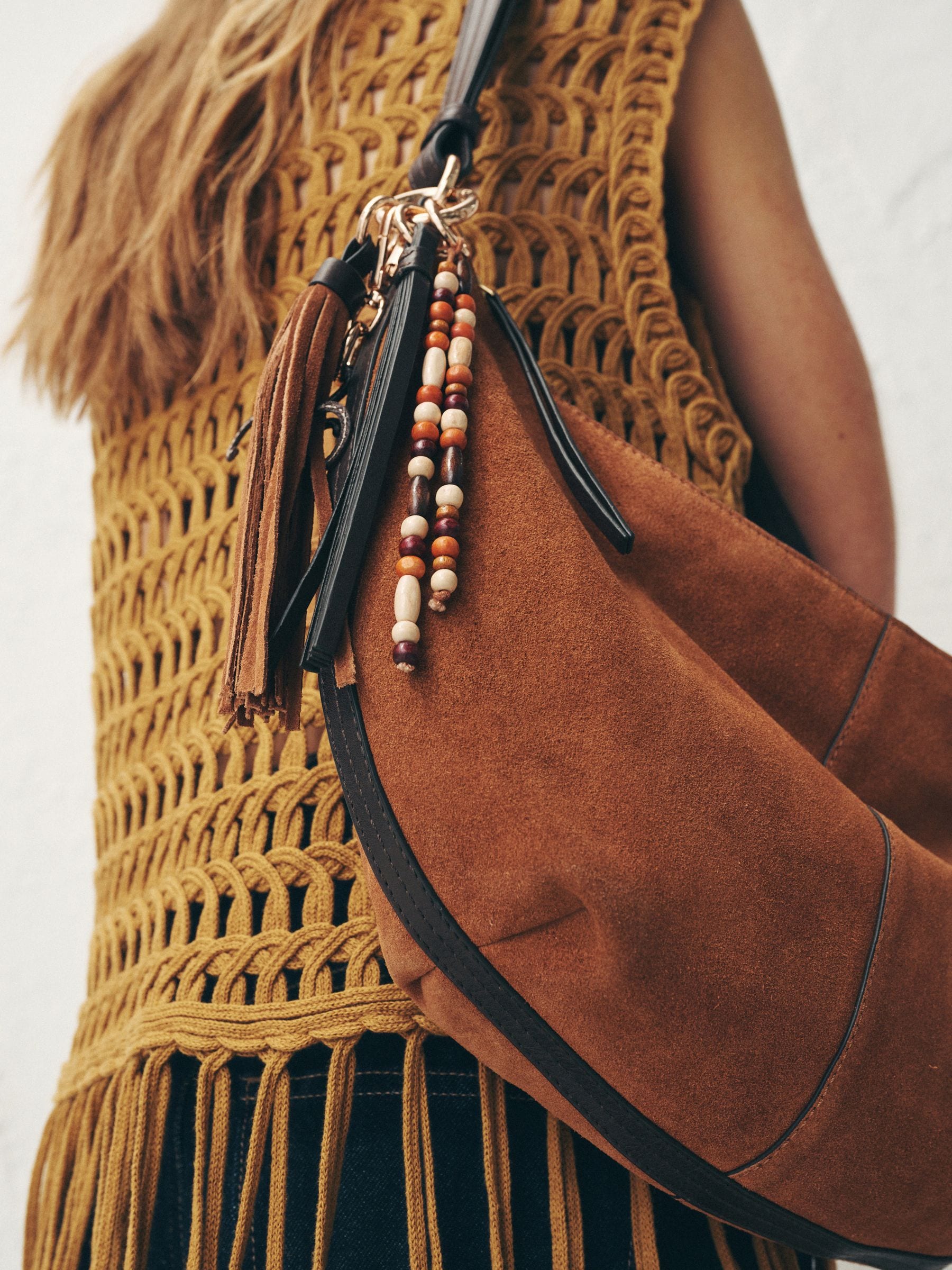 Tan brown suede charm sling bag with tassel, imported from the UK