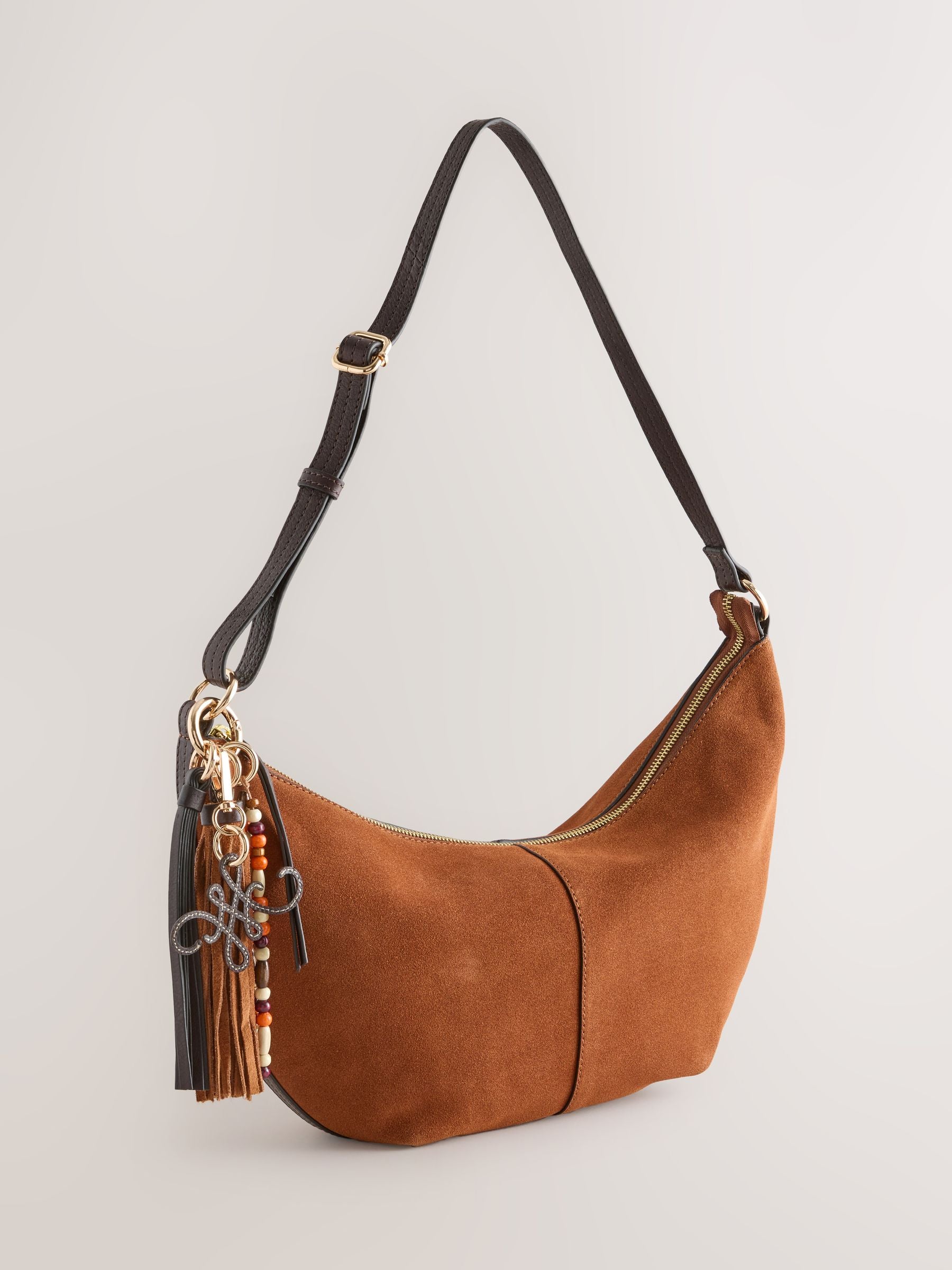 Tan brown suede charm sling bag with tassel, imported from the UK