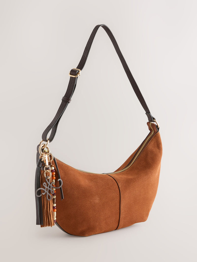 Tan brown suede charm sling bag with tassel, imported from the UK