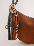 Tan brown suede charm sling bag with tassel, imported from the UK