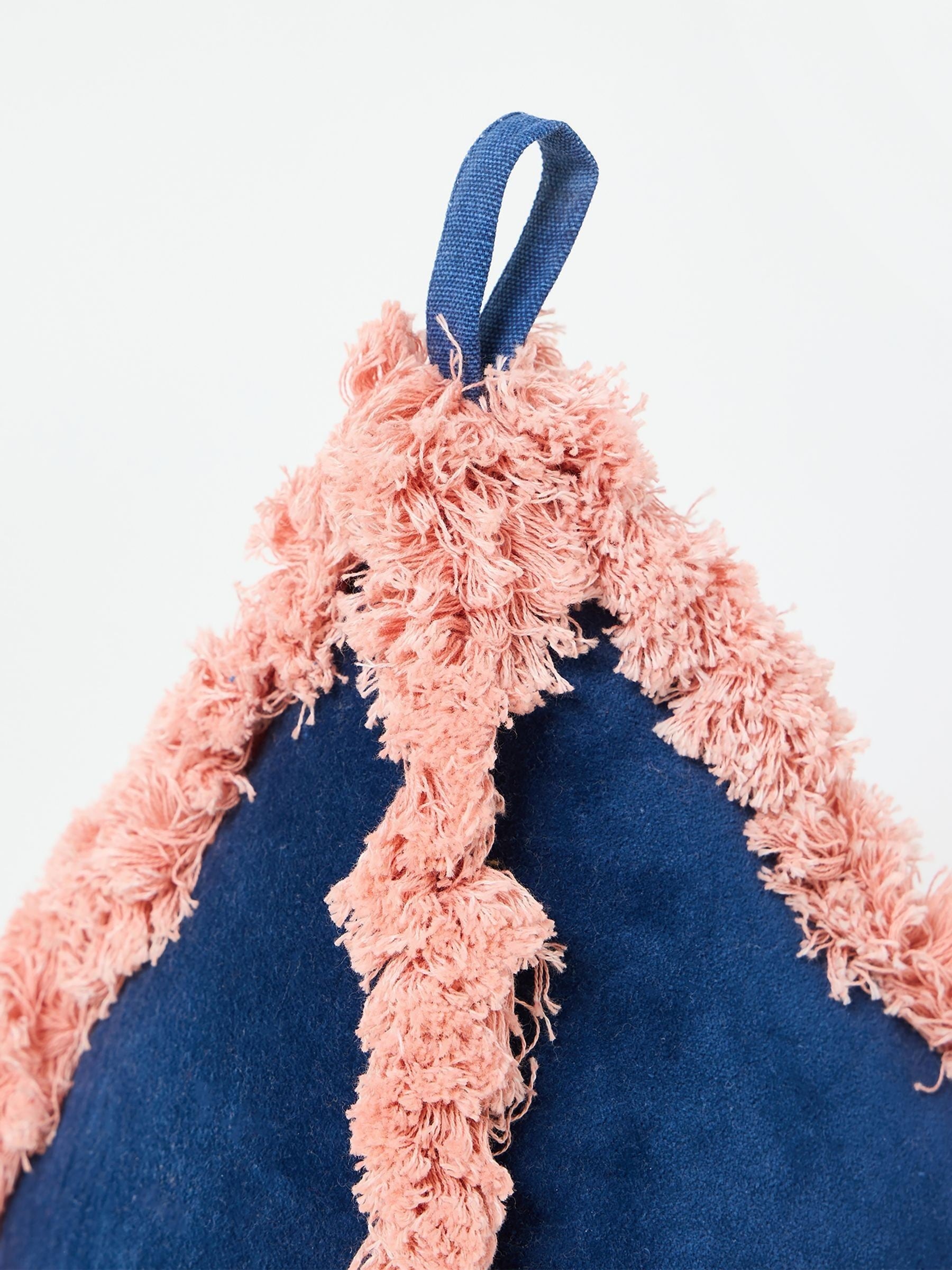 Oliver Bonas blue velvet door stop with pink trim, imported from the UK