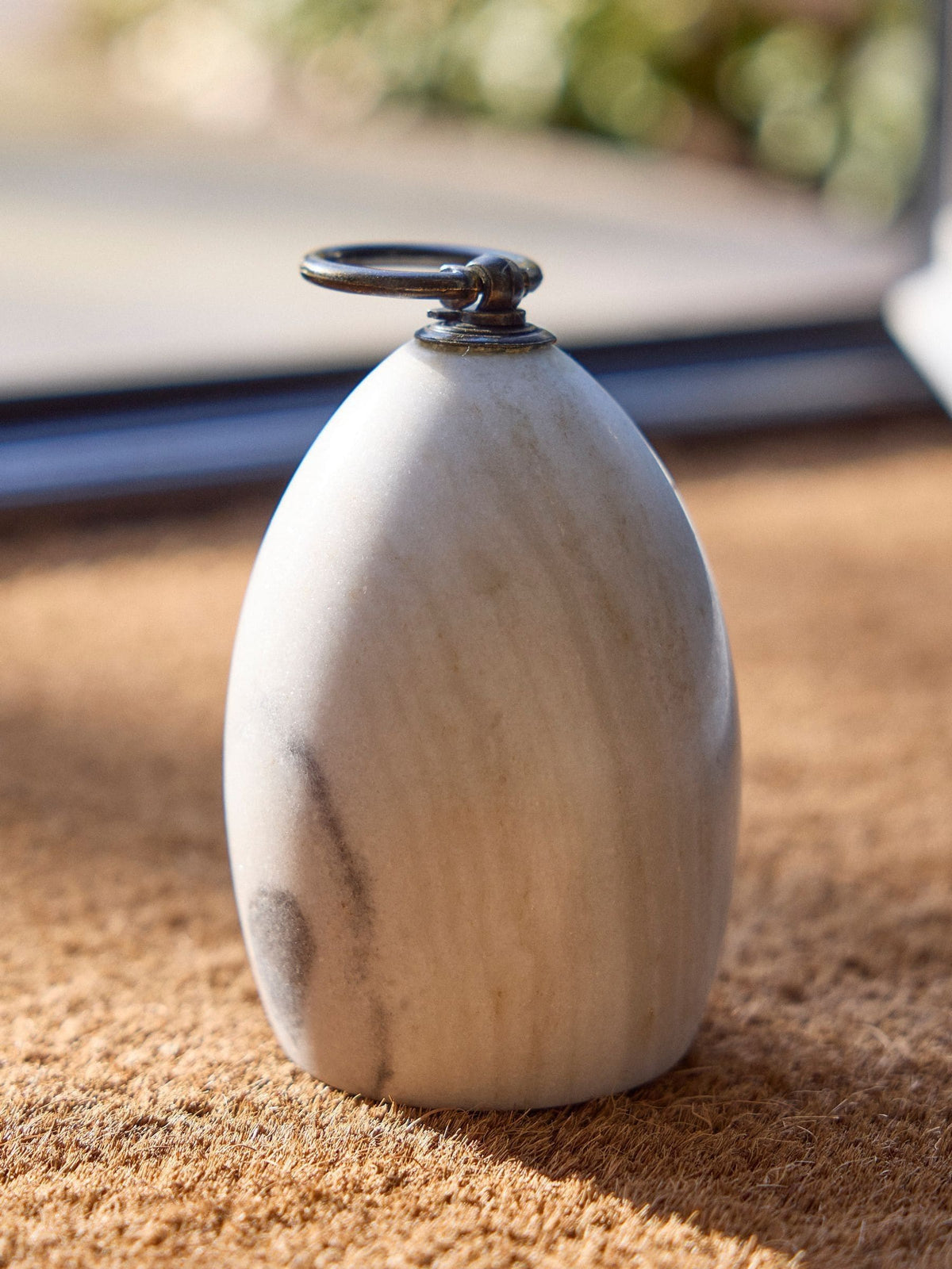 Dibor white marble doorstop with metallic ring, imported from the UK