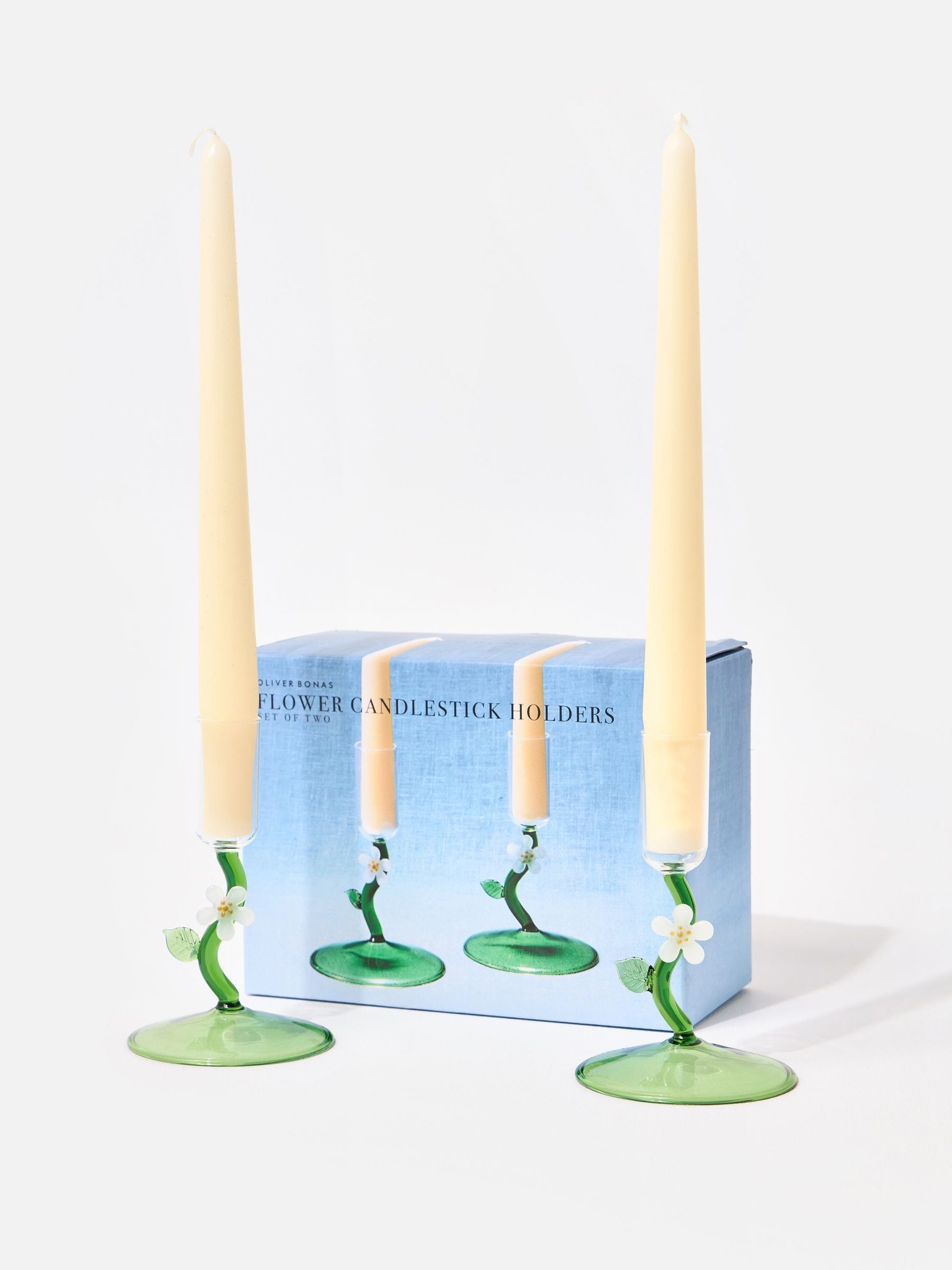 Oliver Bonas green glass candlestick holders with flower motifs, imported from the UK