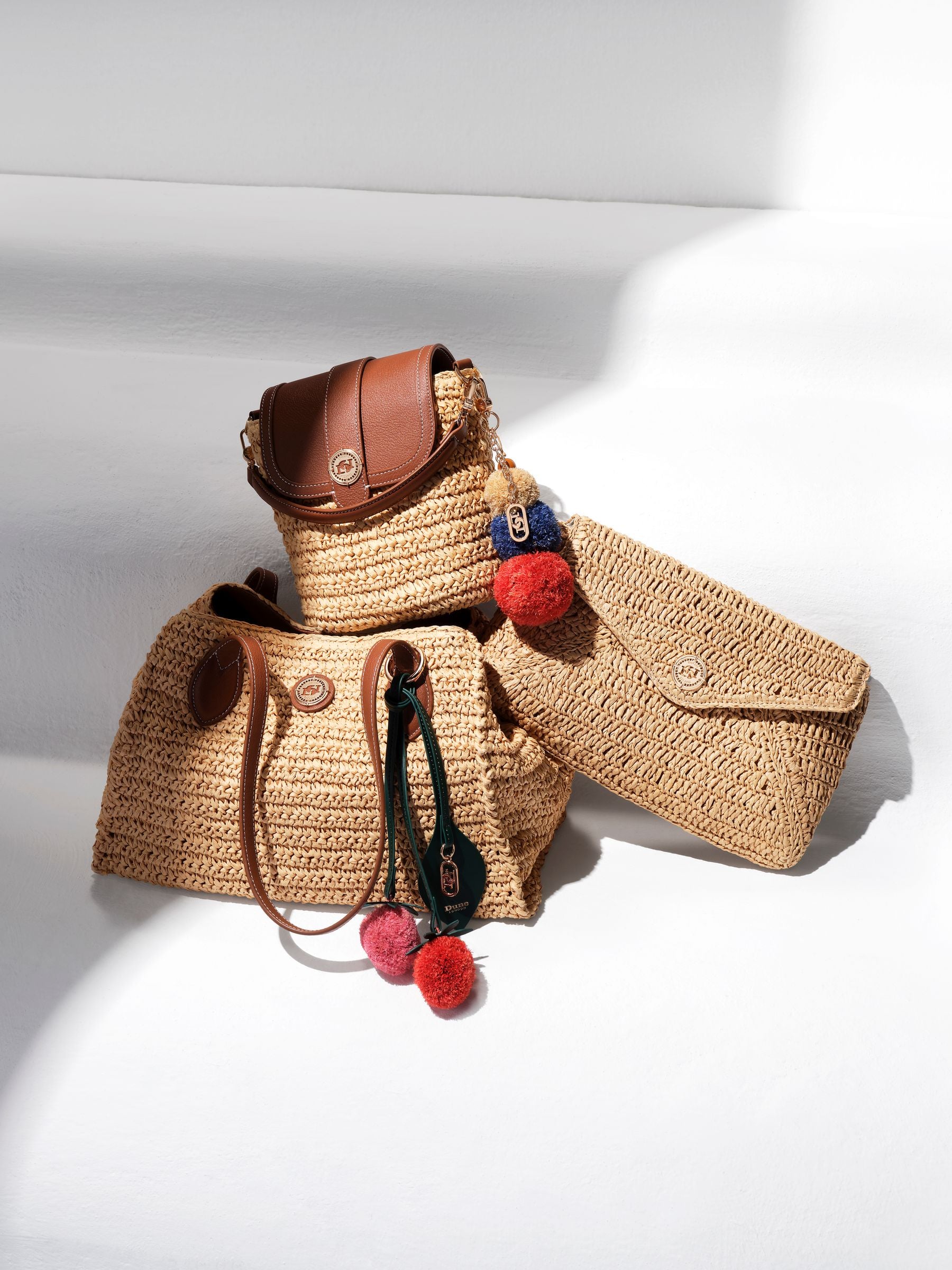 Dune London Dimple cross-body bag in synthetic raffia (British brand)
