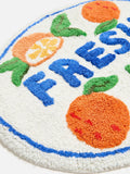 Oliver Bonas orange fresh round tufted bath mat, imported from the UK