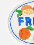 Oliver Bonas orange fresh round tufted bath mat, imported from the UK