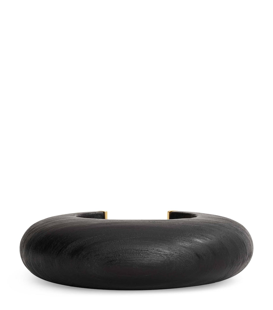 Alaïa wood and brass bumper cuff, imported from the UK