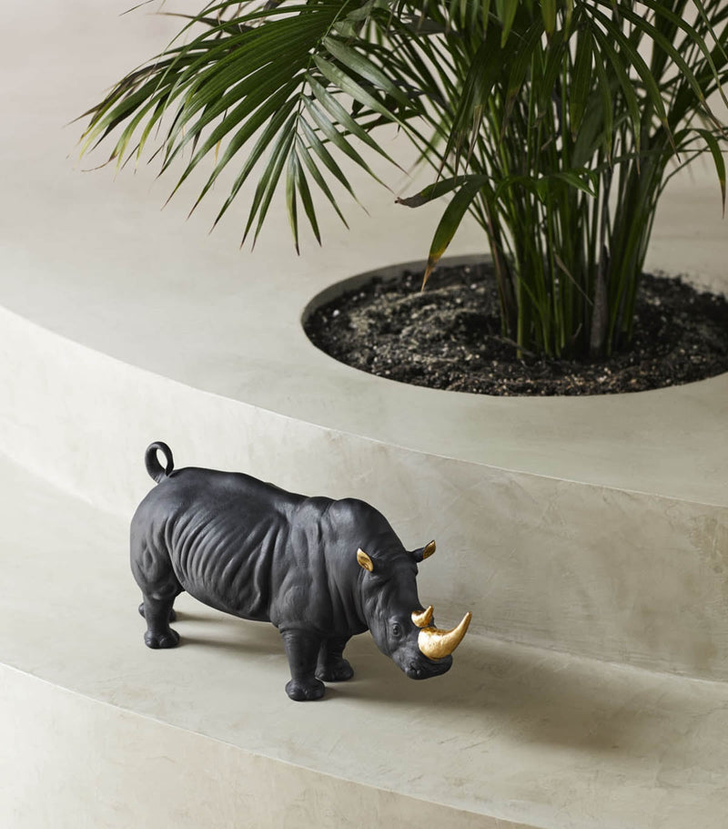 Lladró porcelain rhino figurine with gold accents, 22cm high, UK version