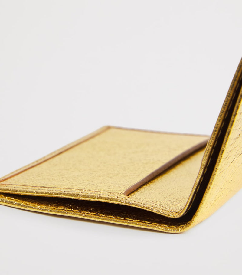 Comme des Garçons vertical card holder with gold metallic accent, imported from the UK