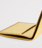 Comme des Garçons vertical card holder with gold metallic accent, imported from the UK