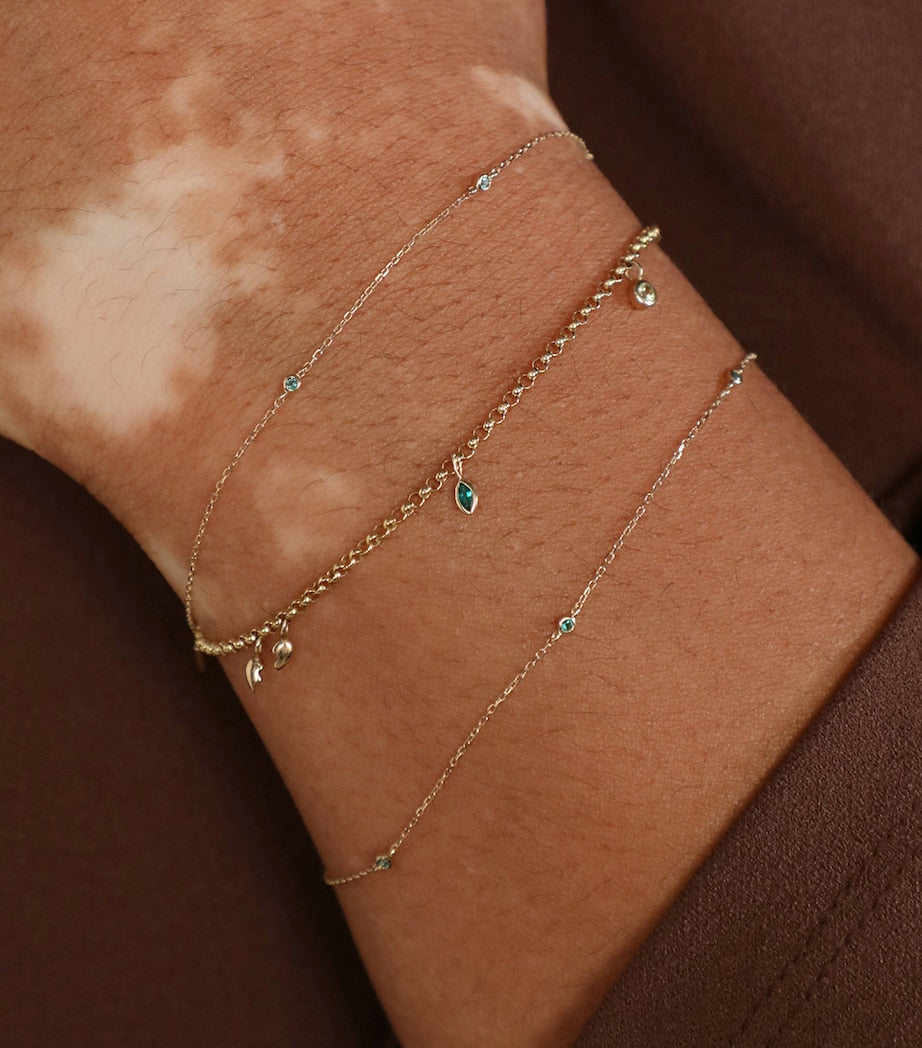 Astrid & Miyu 14k gold emerald charm bracelet, UK version