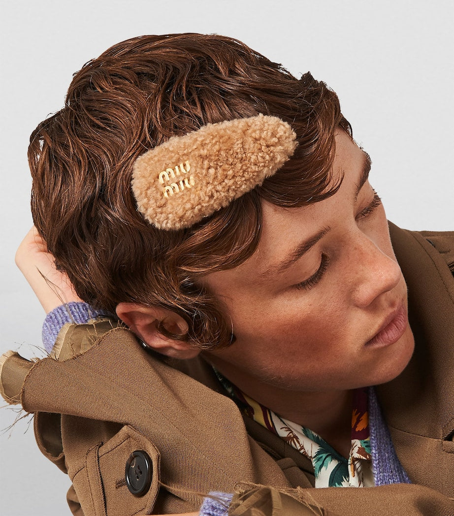 Miu Miu shearling logo hair clip with gold-tone hardware, imported from the UK