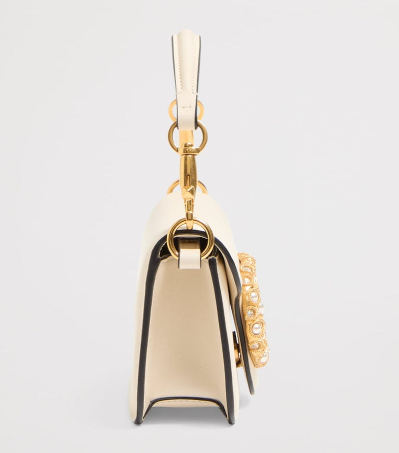 Valentino Garavani Small Embellished Locò shoulder bag, imported from the UK