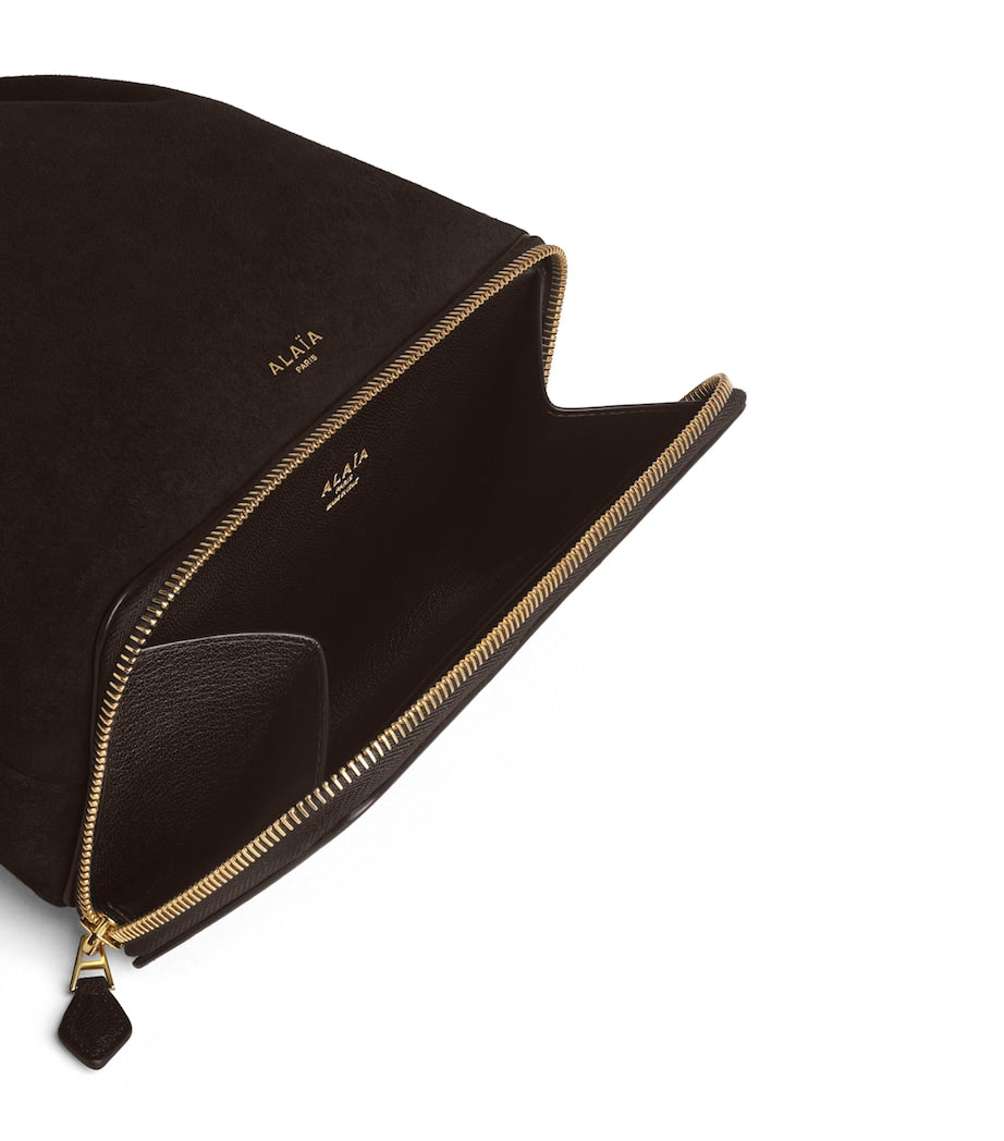 Alaïa Le Ponchon suede cross-body bag, imported from the UK