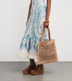 Chloé handwoven banana tote bag with gold charm, imported from the UK