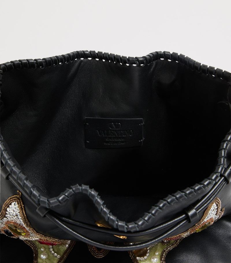 Valentino Garavani Nellcôte lambskin bucket bag with butterfly motif, imported from the UK