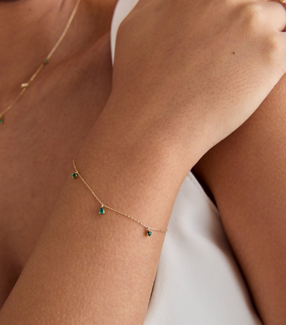Astrid & Miyu yellow gold emerald charm bracelet, imported from the UK