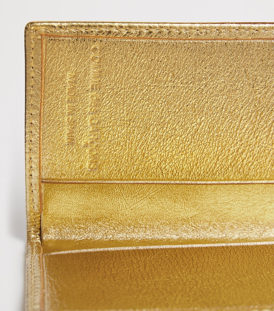 Comme des Garçons vertical card holder with gold metallic accent, imported from the UK
